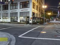 an intersection has a traffic light and a red stop sign on the corner of it