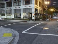 an intersection has a traffic light and a red stop sign on the corner of it