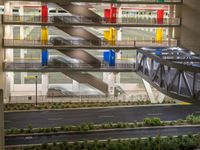 a view of a road and an overpass with traffic passing through it by buildings