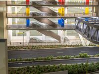 a view of a road and an overpass with traffic passing through it by buildings