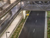 a view of a road and an overpass with traffic passing through it by buildings