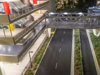 a view of a road and an overpass with traffic passing through it by buildings