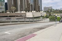 a red fire hydrant sitting on the side of a road by buildings'curb