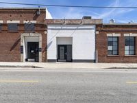 an image of a old building and some telephone wires, no cars in the street