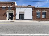 an image of a old building and some telephone wires, no cars in the street