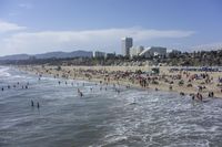 a crowded beach with people and umbrellas during the day, in mexico's atlantic states