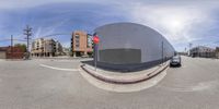 a fisheye lens is shown showing a parking area in the distance and a large building in the far corner