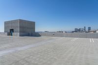 the roof of a parking lot has two tall buildings on each side of it with city skylines