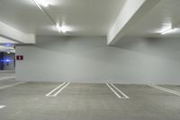 the large empty car park has no parking spots on the floor or walls at the edge