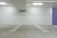 the large empty car park has no parking spots on the floor or walls at the edge