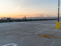 the tarmac with cars on it, and mountains behind it is cloudy and bright