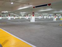 a car park has a large parking lot with white walls and yellow flooring,