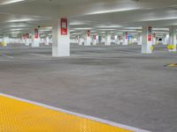 a car park has a large parking lot with white walls and yellow flooring,