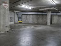 a parking garage with a no dumping sign and yellow bench area seatbelts on the concrete floor
