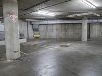 a parking garage with a no dumping sign and yellow bench area seatbelts on the concrete floor