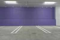 the empty garage has an empty parking space and is blue and purple in color and sizes