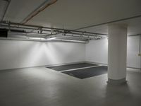 a parking garage with a very high ceilinged room and black mat in the floor