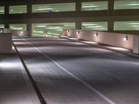 a view of a road and an overpass with traffic passing through it by buildings