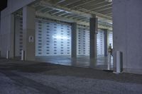 the parking garage has two signs on the wall, one in front of the garage door and another in back