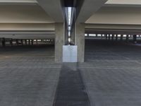 an overhead parking garage filled with lots of space for storage purposes and parking spots on the pavement