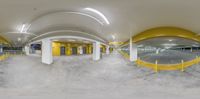 the panorama of a yellow and white garage from inside the parking garage area of the new business building