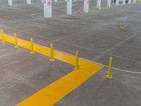 a parking lot that has a yellow strip of tape marking it off and to the left