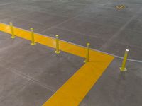 a parking lot that has a yellow strip of tape marking it off and to the left