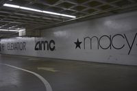 a parking garage with a wall that says mr macy on it and is painted with the name marc