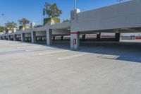 two parking garages in an outdoor parking lot area, one of them painted red