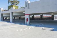 two parking garages in an outdoor parking lot area, one of them painted red