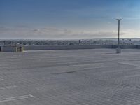 a parking lot that has a few vehicles parked in it with a blue sky above