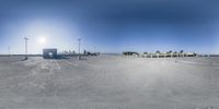 a 360 - fisheye photo of parking lot area for a city park where two vans parked