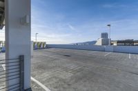 a parking lot with parking meters and a blue sky in the background for commercial use