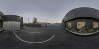 a 3d photo of a parking lot with circular buildings on either side of them in the evening