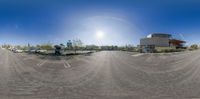 a circular panoramic view of a parking lot in front of a large building