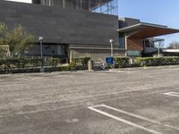 an empty parking lot in front of a building that has been designed to look like a mall