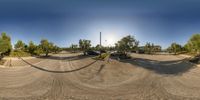 there is a circular view of a parking lot with three cars parked in it on the left side of it