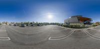 a fish eye lens view of a parking lot and a large building with a yellow roof