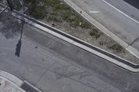 an overhead shot of a street and the sidewalk taken from a top - up view