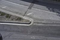 an overhead shot of a street and the sidewalk taken from a top - up view
