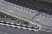 an overhead shot of a street and the sidewalk taken from a top - up view