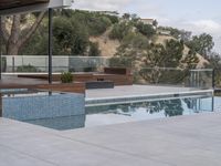 an above ground swimming pool and hot tub at the top of the hill overlooking a mountain