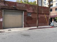 the entrance to the parking garage of an apartment building in a city street with no cars