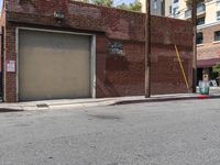 the entrance to the parking garage of an apartment building in a city street with no cars