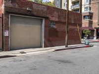 the entrance to the parking garage of an apartment building in a city street with no cars