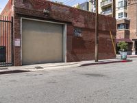 the entrance to the parking garage of an apartment building in a city street with no cars