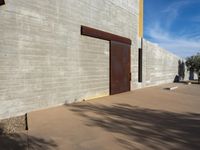 a view of the outside of a large brick building with a door on it's side