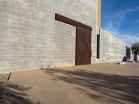 a view of the outside of a large brick building with a door on it's side