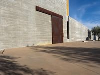 a view of the outside of a large brick building with a door on it's side