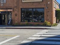 a restaurant sitting on the corner of a street in an intersection with a crosswalk